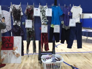 Students explored fair and unfair trade practices today; the "stained and bloodied" clothes represent companies whose manufacturing practices are abusive and exploitative